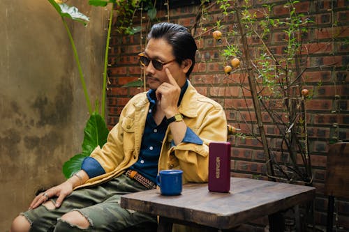 Man Sitting at the Table in Cafe Patio 