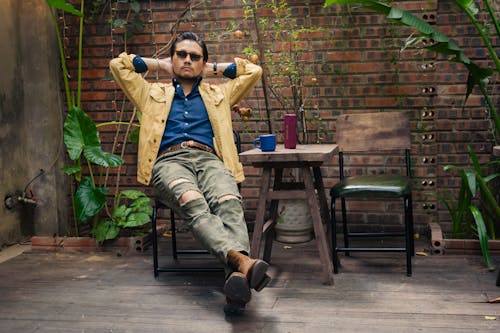 Man Sitting at the Table in Cafe Patio 