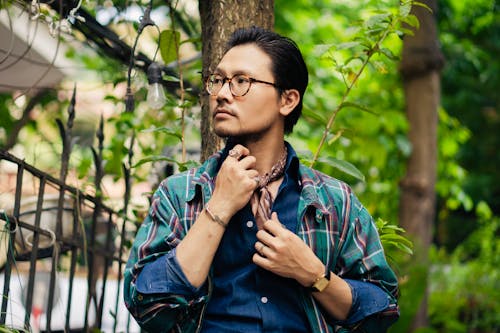 Fashionable Man Standing Outside on the Background of Trees