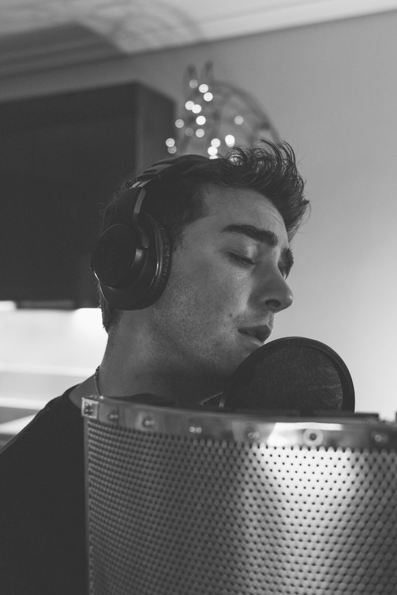 Singer recording a vocal performance in a studio
