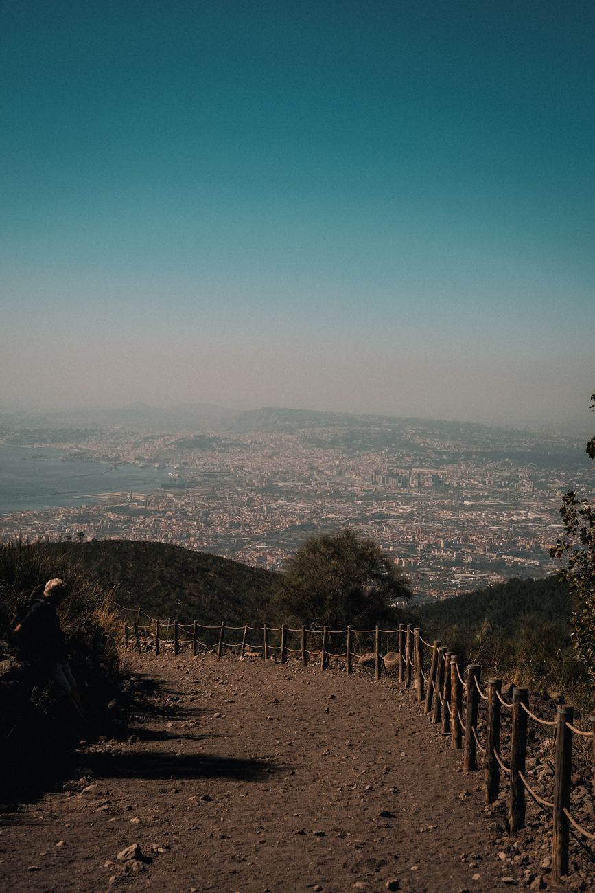A stunning high-angle cityscape view from a hillside trail, showcasing urban life and natural beauty.