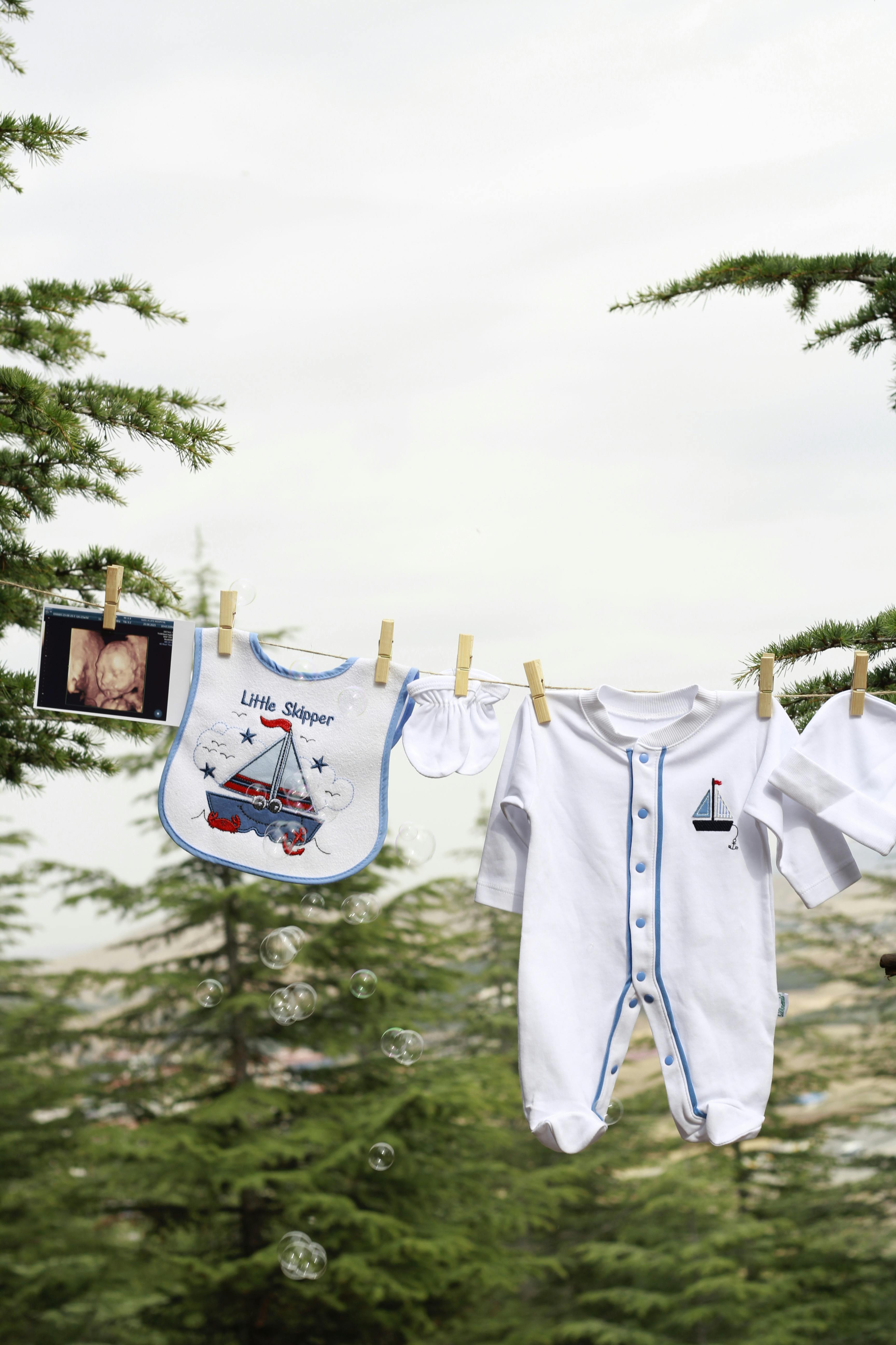 Newborn Clothes and an Ultrasound Drying in the Yard · Free Stock Photo