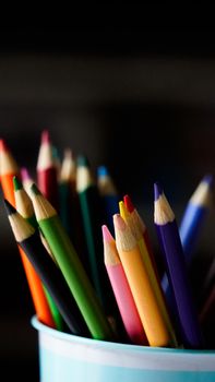 Vivid assortment of colored pencils in a cup, perfect for creative projects and design inspiration.