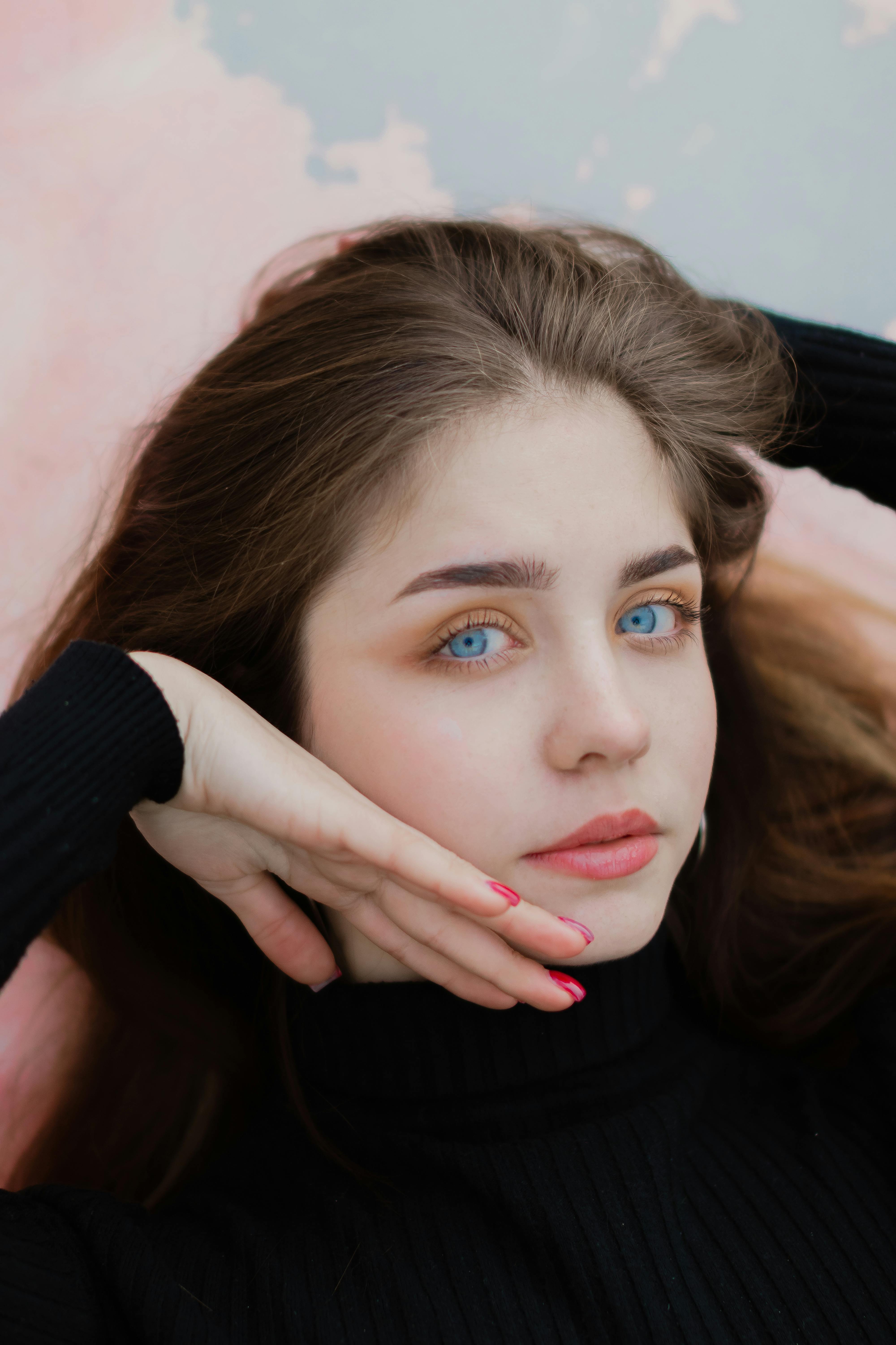 Smiling young model in a white turtleneck posing in front of a