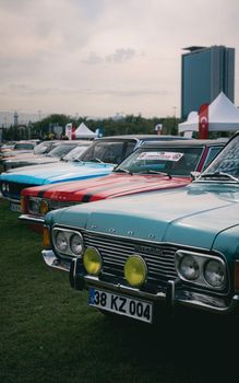 Lineup of classic Ford cars at an outdoor auto show, featuring vintage models.