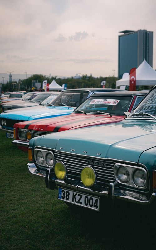 Free Lineup of classic Ford cars at an outdoor auto show, featuring vintage models. Stock Photo