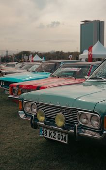 Line of vintage Ford cars displayed at an outdoor classic car exhibition.