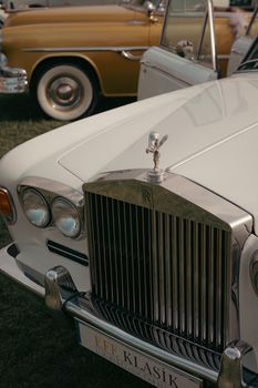 Close-up of a Rolls-Royce Silver Shadow at a classic car show featuring luxury details like the Spirit of Ecstasy mascot.