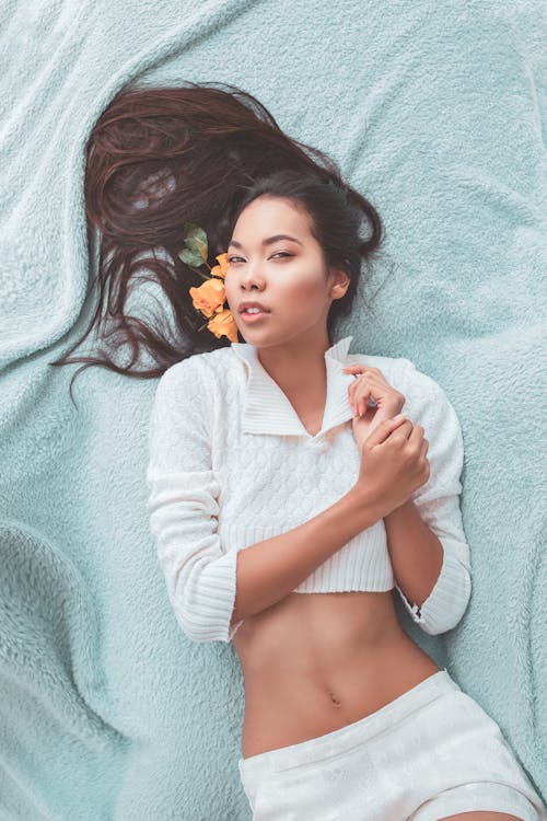 Woman Lying On Cloth Wearing White Top