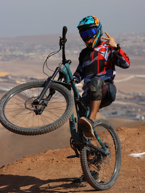 Man Posing on Bike on Hilltop on Desert