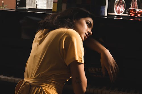 Woman Wearing Dress Beside Piano