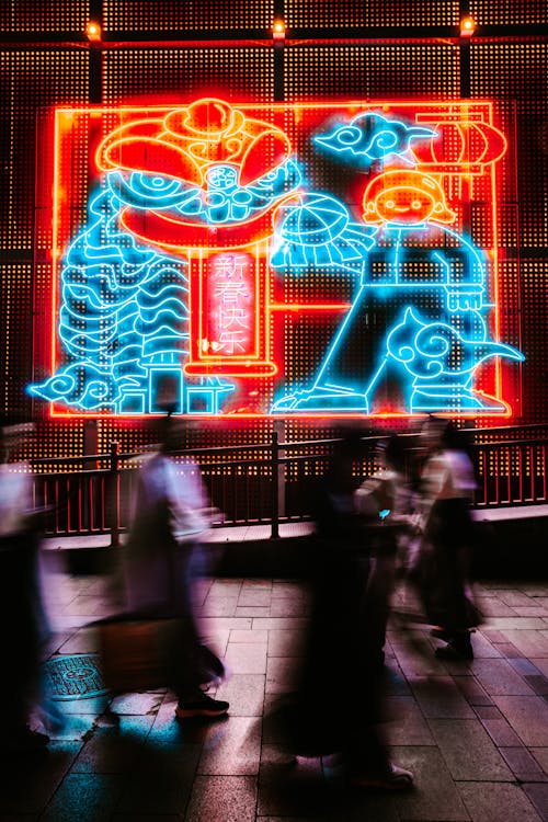 Neon on Wall behind People at Night