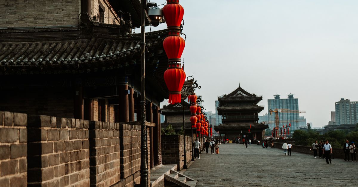Historic city wall adorned with red lanterns in Xi'an, reflecting Chinese heritage.