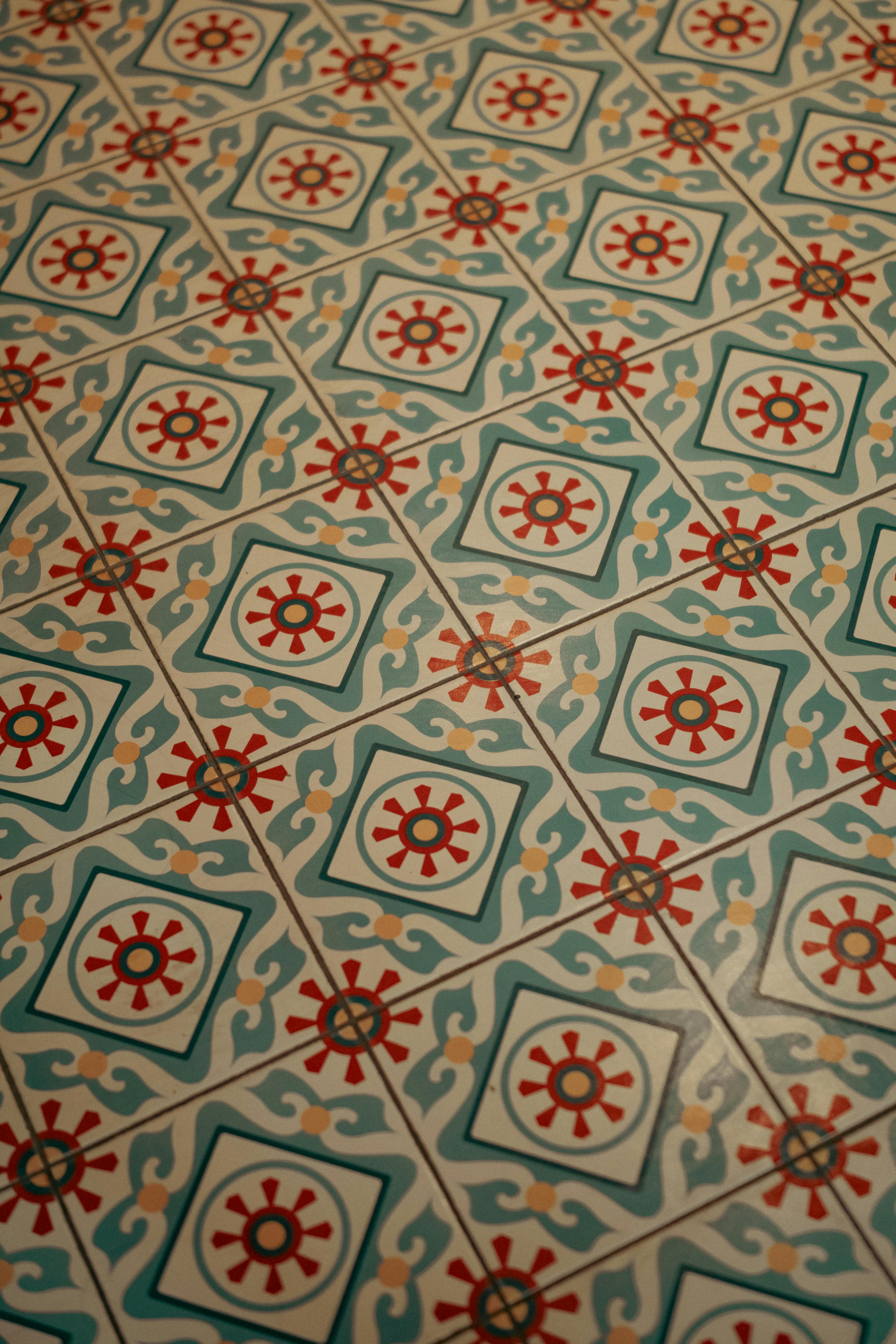 Intricate artistic floor tile pattern with vibrant colors and unique design.