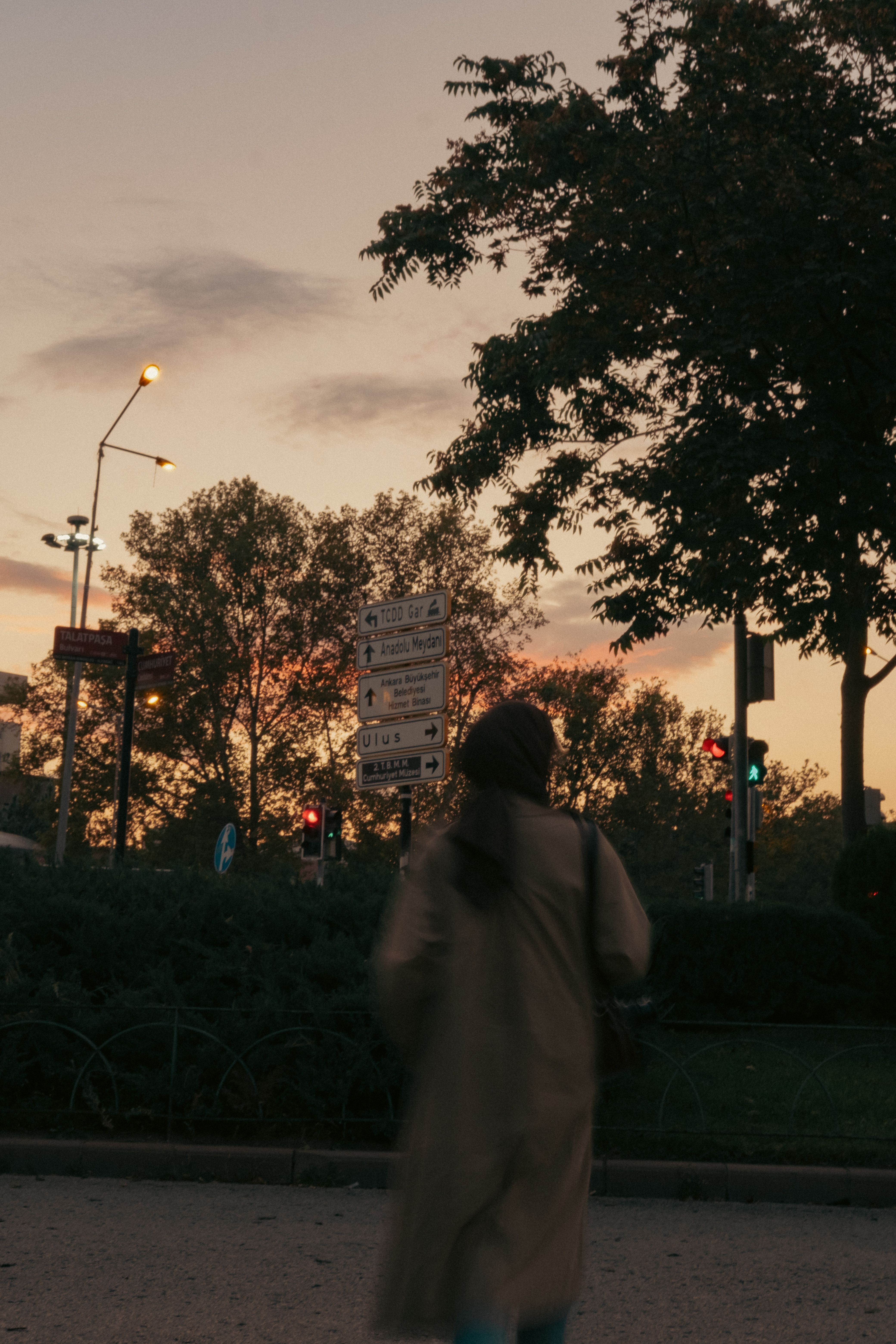 Woman in a Trench Coat Walking Outside at Sunset · Free Stock Photo