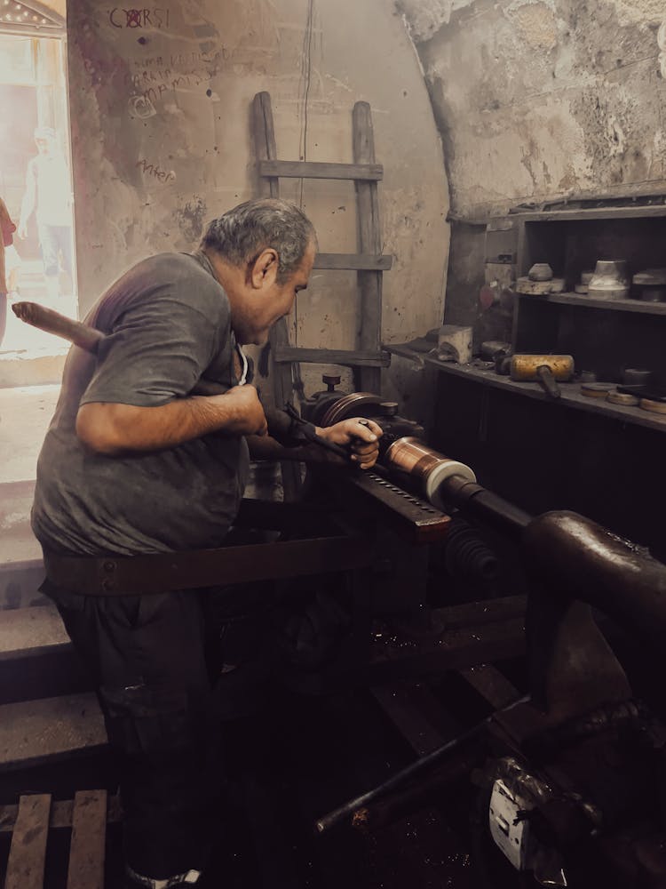 Turner Working On A Lathe In A Workshop