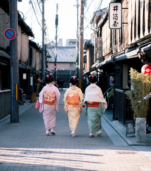 Three Woman Wearing Traditional Dresses Walking On Street