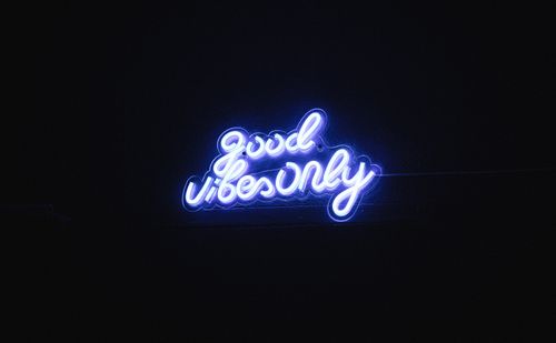 Free A vibrant blue neon sign against a dark background displaying 'Good Vibes Only'. Stock Photo