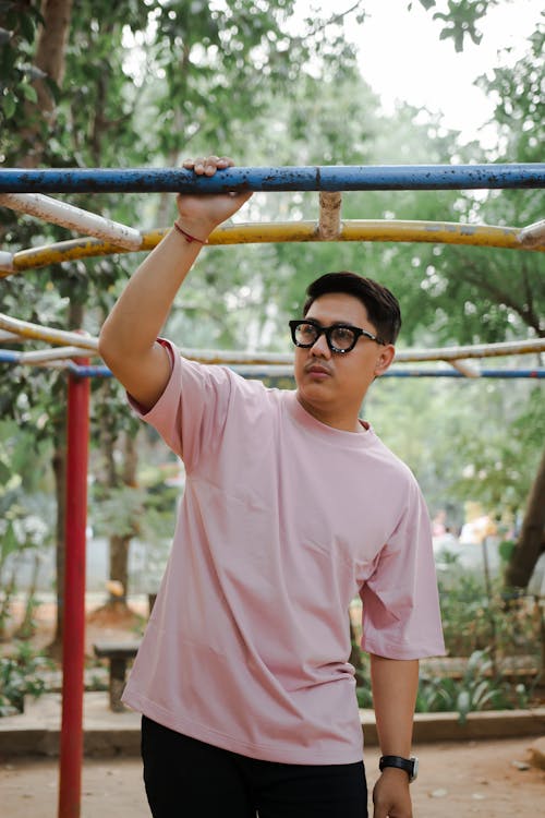 Man in Pink T-shirt Standing on Playground in Park