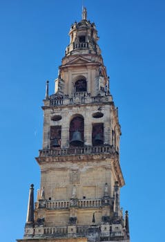 Close-up of the historic bell tower at the Mosque-Cathedral in Córdoba, Spain.