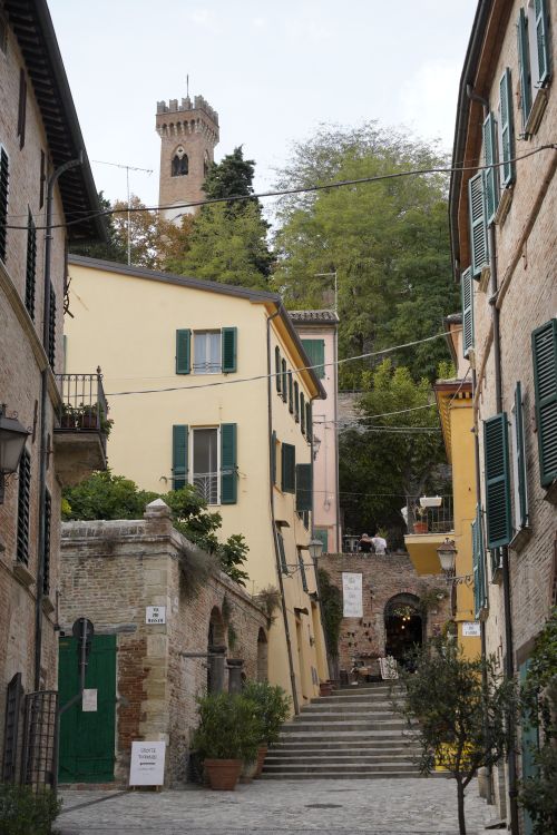 Free Explore a picturesque alley in Santarcangelo di Romagna, featuring historic architecture and lush trees. Stock Photo
