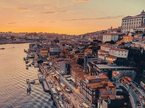 A stunning aerial view of Porto, Portugal's cityscape and riverside at sunset.
