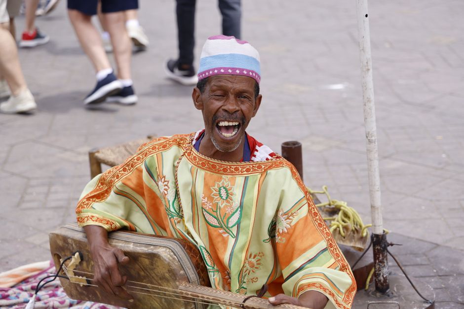 Bustling Djemaa el-Fna square in Marrakech, Morocco, at night with food stalls and performers