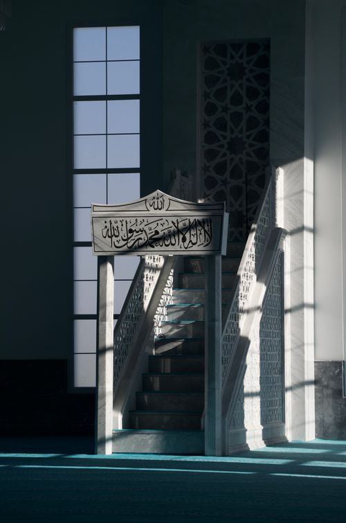 Free Intricately designed interior staircase with Arabic script, capturing beautiful light and shadows. Stock Photo