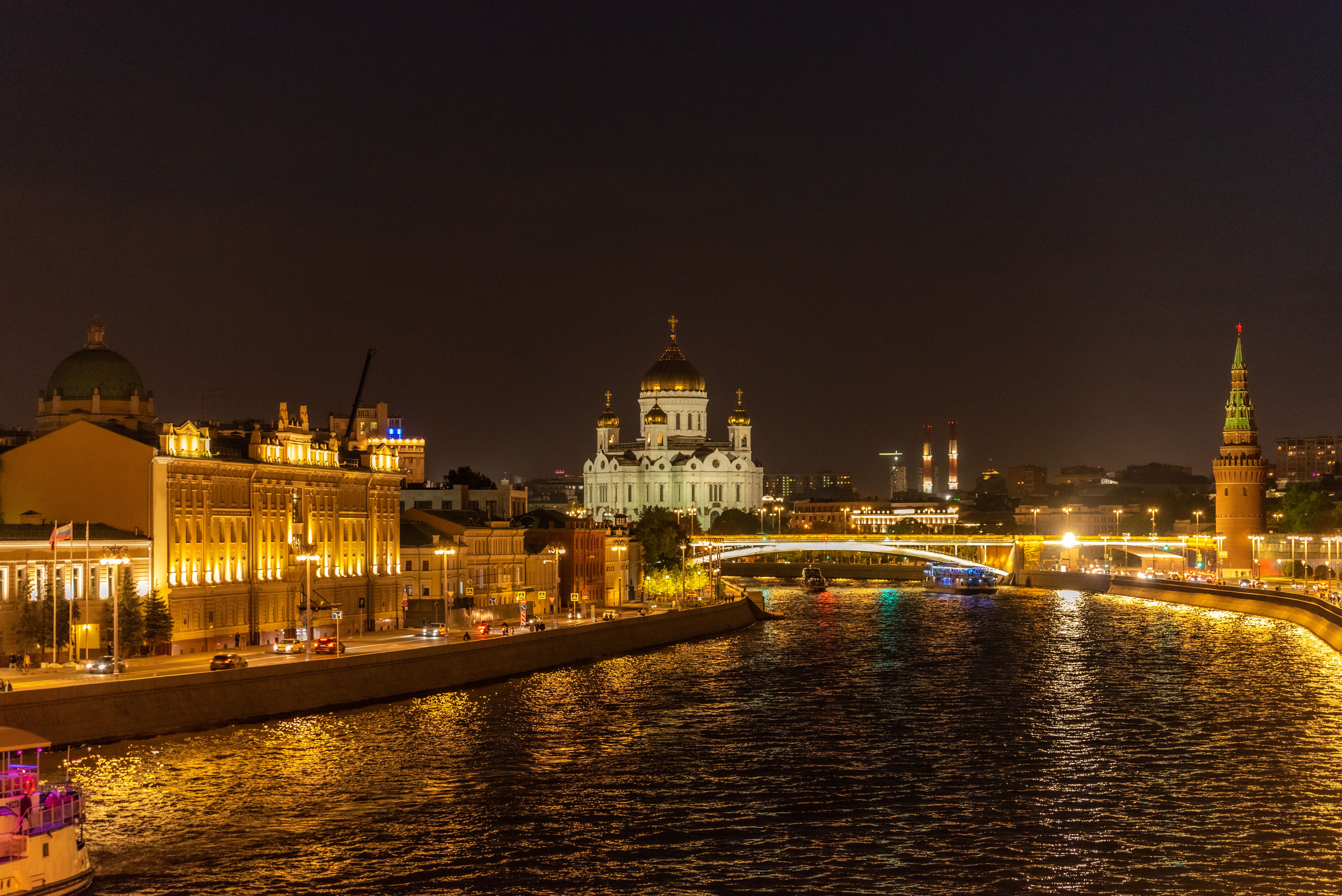 Nighttime view of the Moscow River, Kremlin, and Cathedral in Russia, beautifully illuminated.