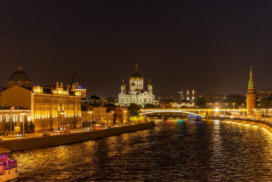 Nighttime view of the Moscow River, Kremlin, and Cathedral in Russia, beautifully illuminated.