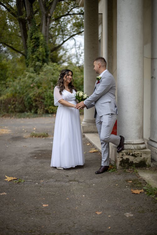 Newlyweds Standing by Building Column