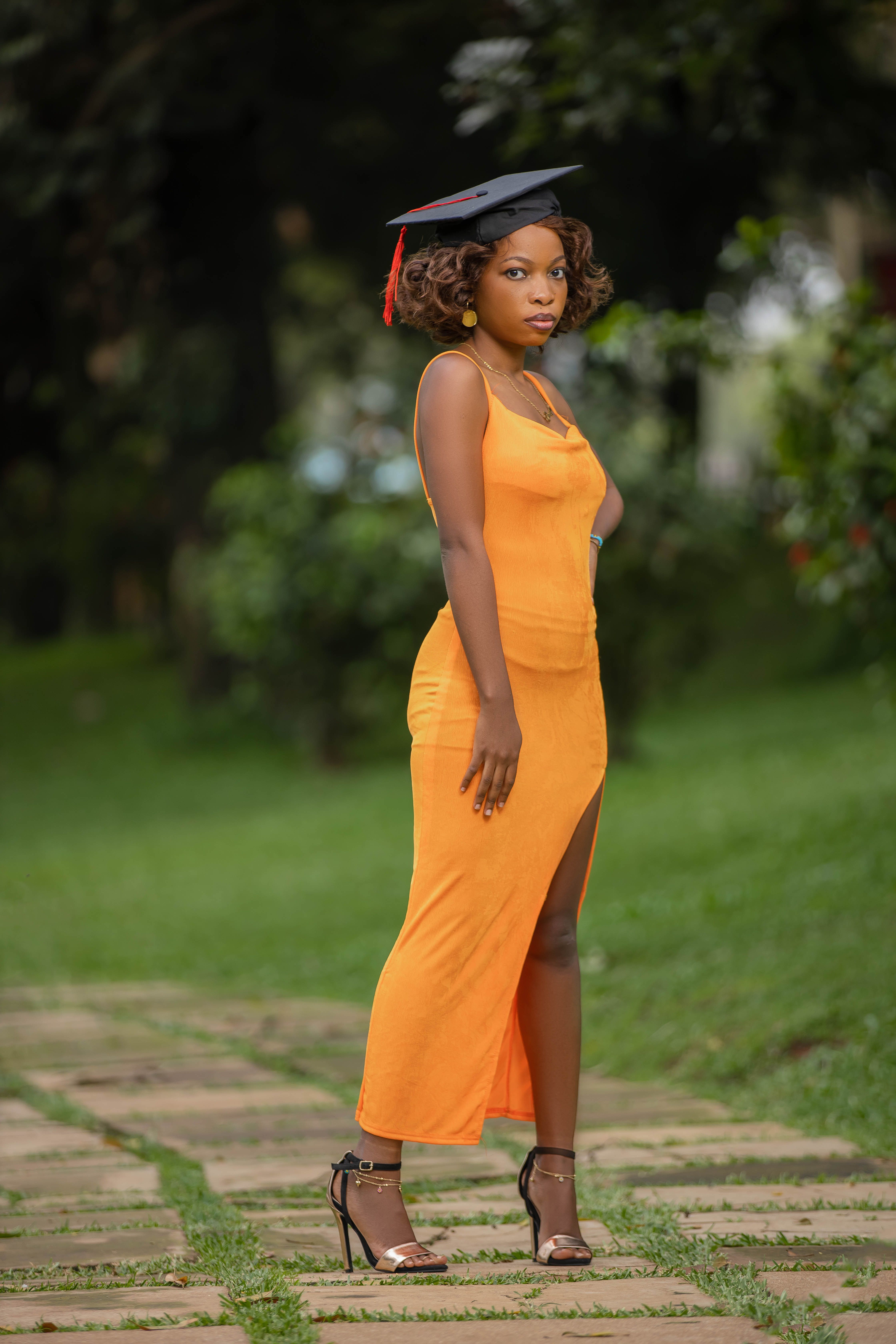Woman in Orange Dress and Academic Hat  Free Stock Photo