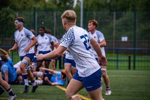 Men in White Jerseys at Football Pitch