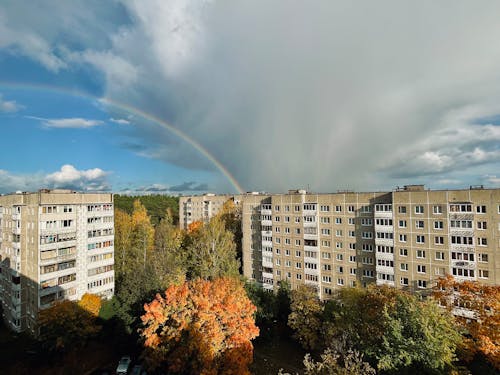 Cloud and Rainbow over Blocks of Flats in Town