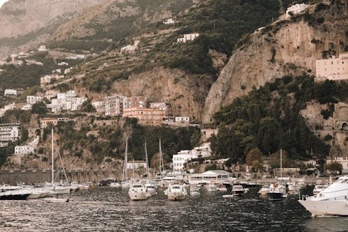 Motor Yachts Moored in Bay in Town on Amalfi Coast