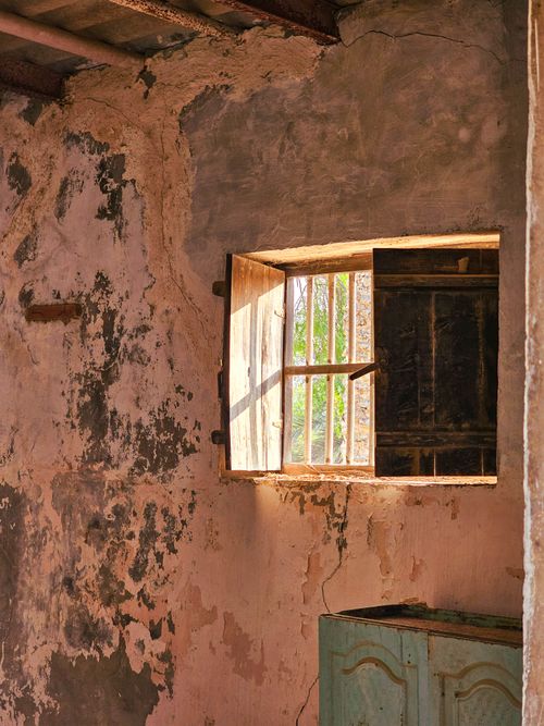 Free Explore the rustic charm of an abandoned room with sunlight streaming through an open window in Qeshm, Iran. Stock Photo