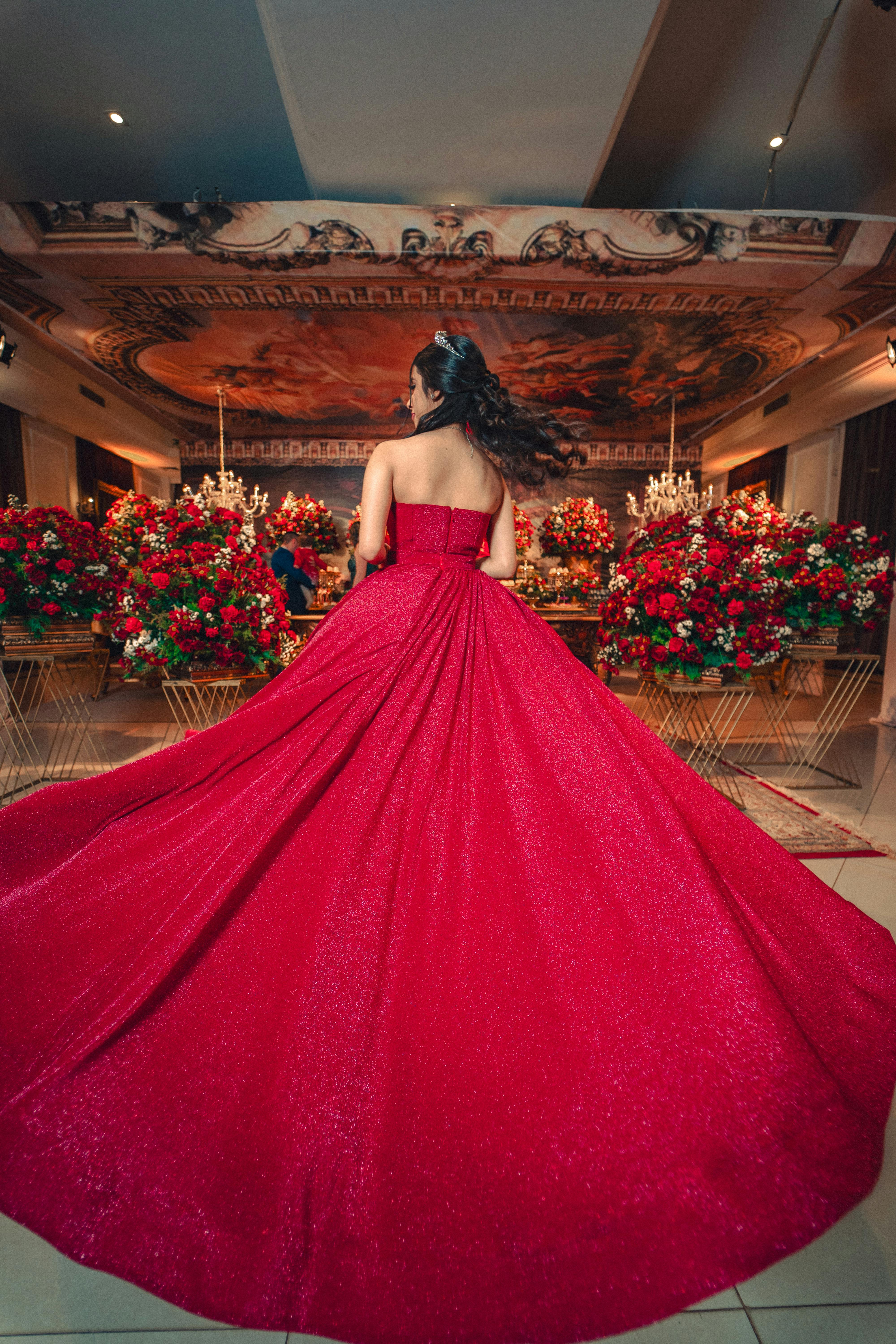 A Teenage Girl in a Red Dress Posing at her Birthday Party Free Stock Photo