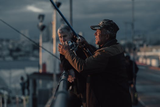 Two men fishing off a bridge in Istanbul during twilight, capturing urban life.