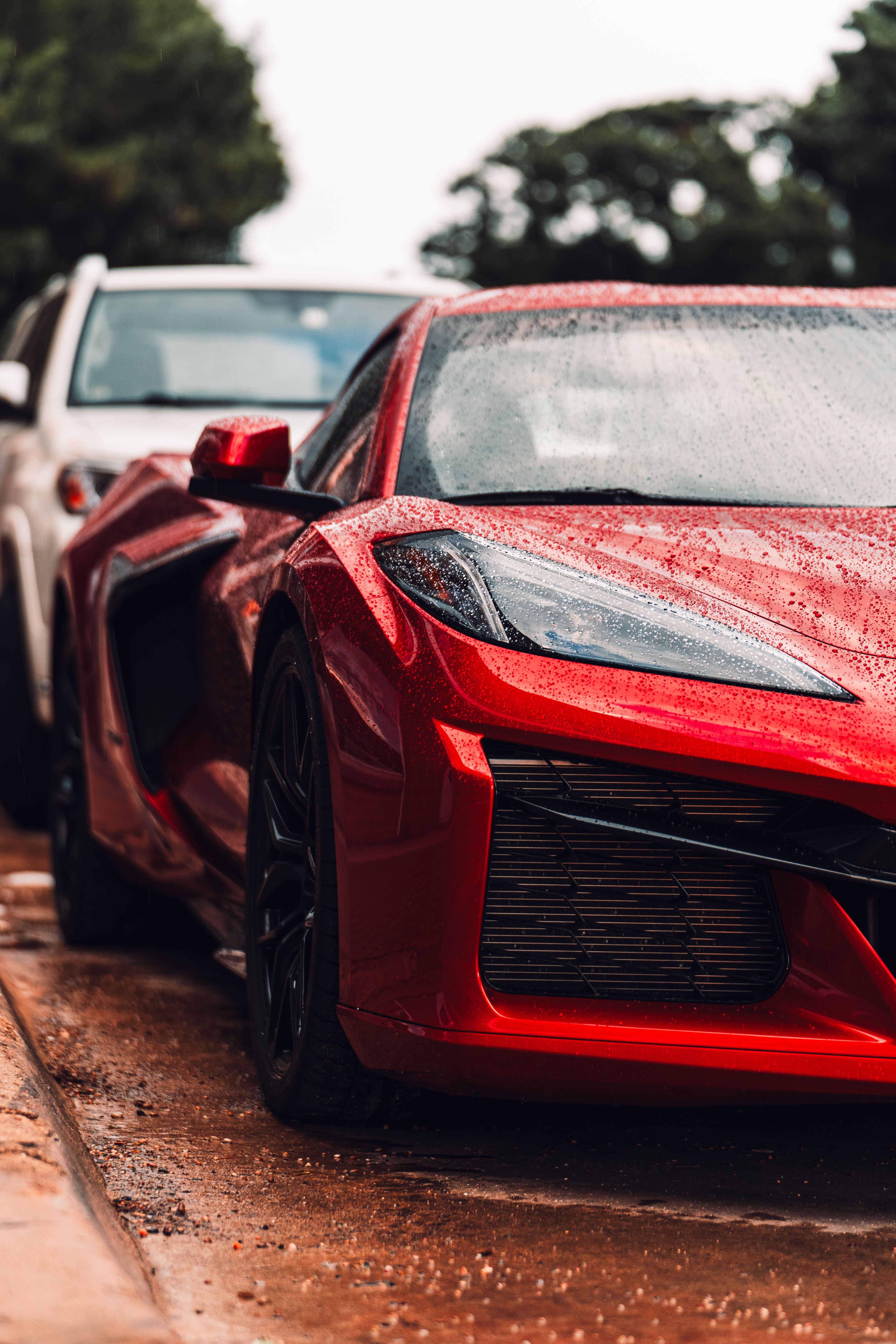 Stunning red supercar glistening with raindrops in Fort Worth, Texas.