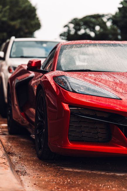 Stunning red supercar glistening with raindrops in Fort Worth, Texas.