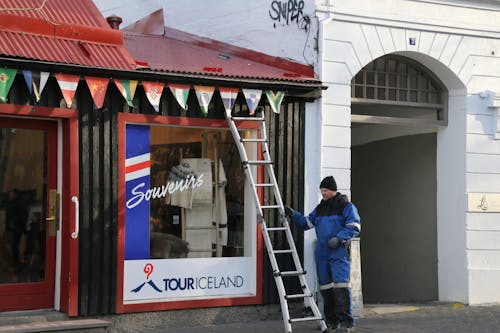 Worker with Ladder by Souvenirs Store