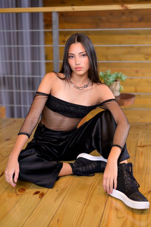 Model Wearing an Black Mesh Blouse and Lycra Pants Sitting on the Floor
