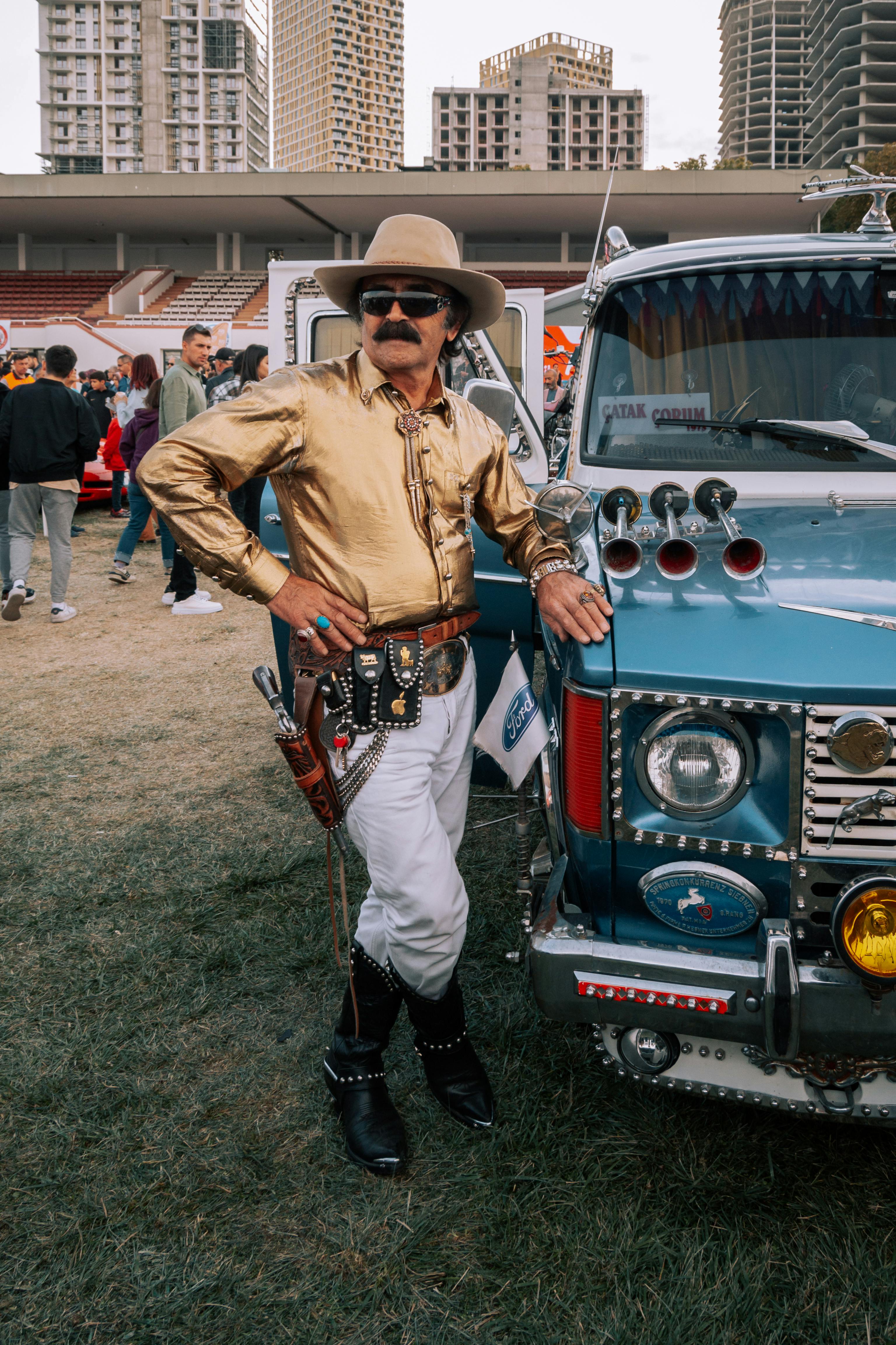 cowboy style man by truck on stadium