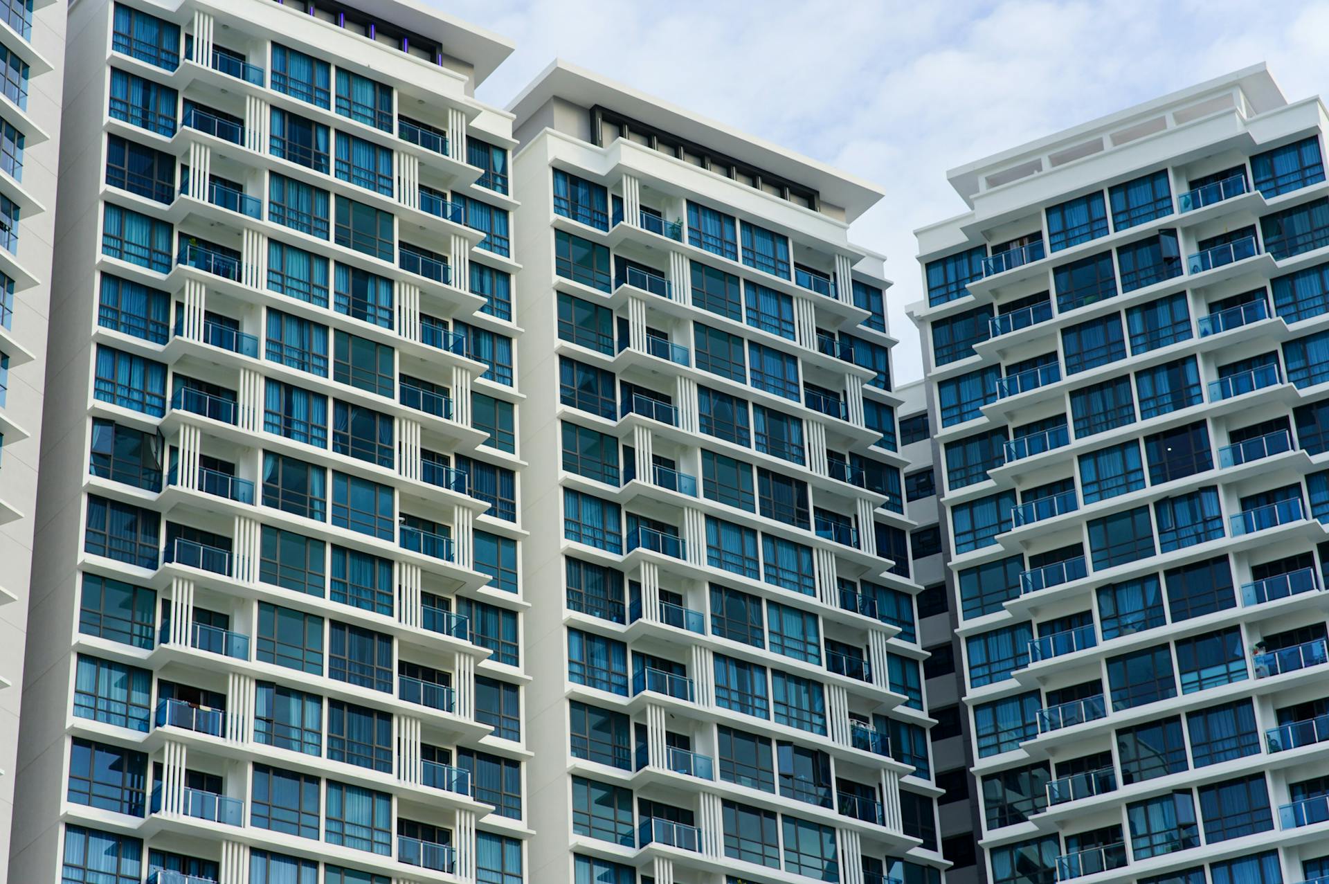 Contemporary high-rise buildings with sleek glass facades in an urban setting.