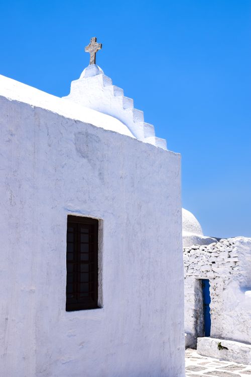 Free Explore the stunning architecture of a whitewashed Greek Orthodox church under the clear blue sky. Stock Photo