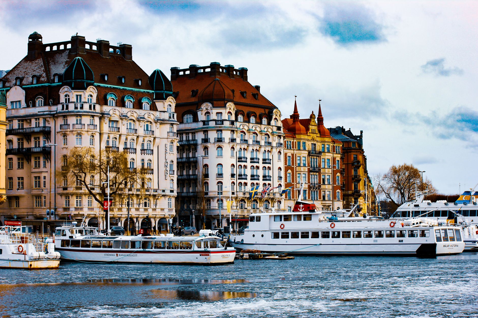 Charming view of Stockholm's classic buildings and moored boats along the waterfront.