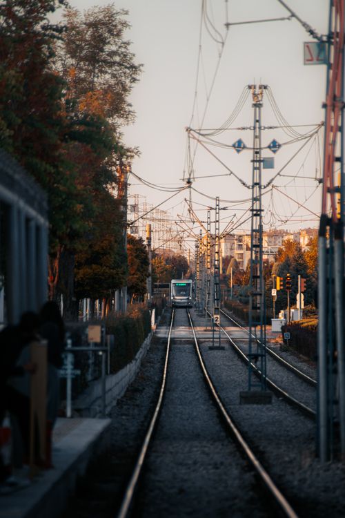 Free A serene view of tram tracks in Konya, Türkiye, framed by autumn foliage and urban infrastructure. Stock Photo