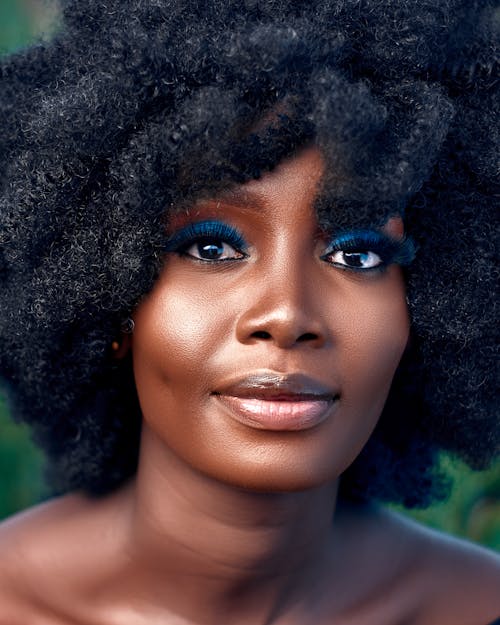 Portrait of a Beautiful Woman with Afro Hair and Blue Eye Makeup 