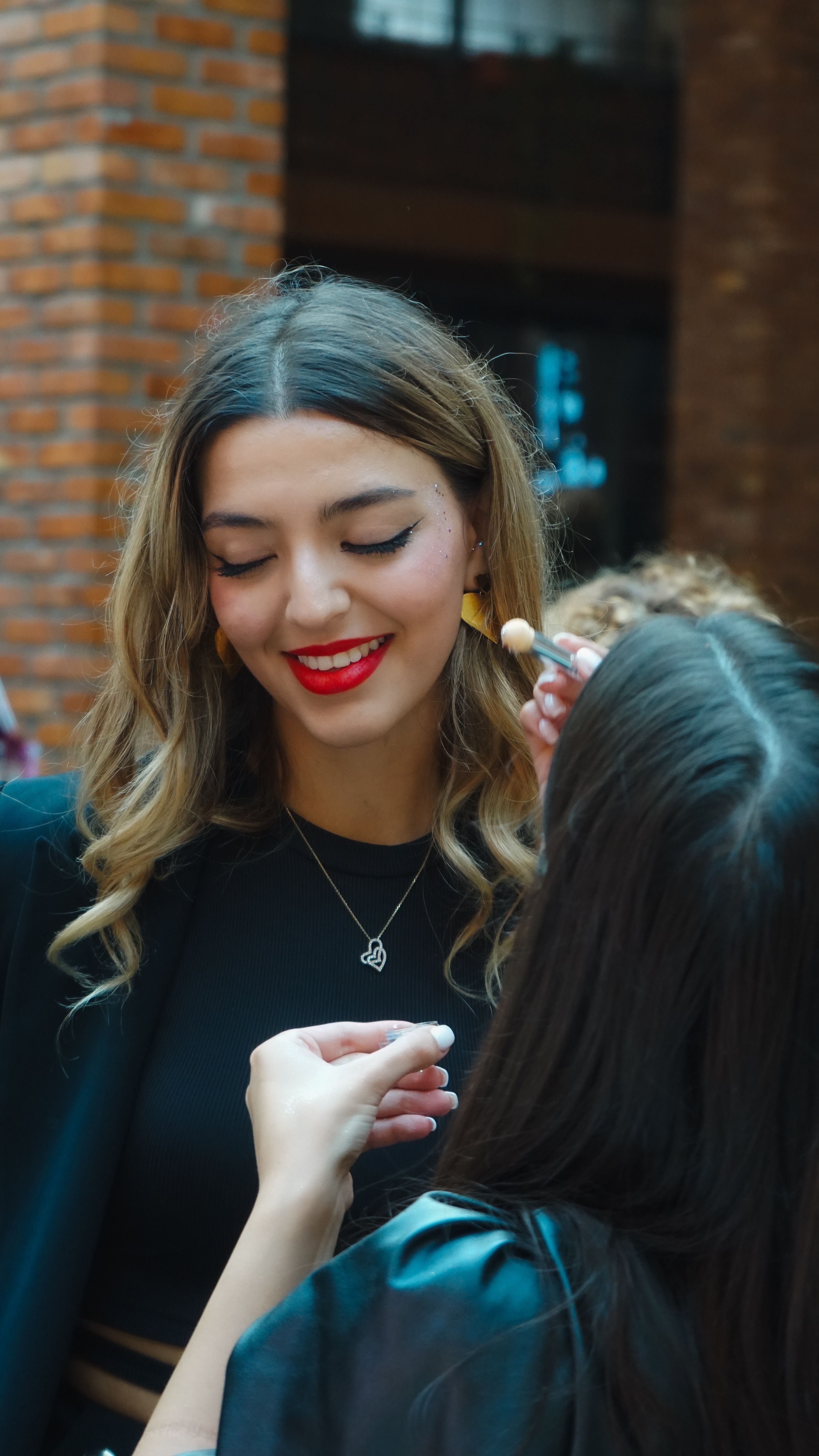 Makeup artist applying finishing touches