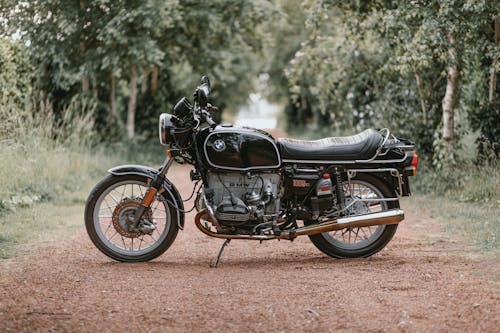 Black Vintage BMW Motorcycle Parked on a Dirt Road